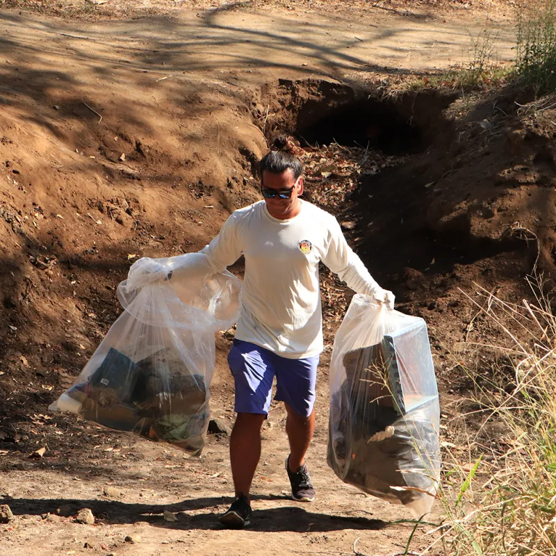 a man that is standing in the dirt