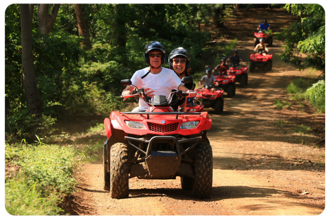 a man riding a motorcycle down a dirt road